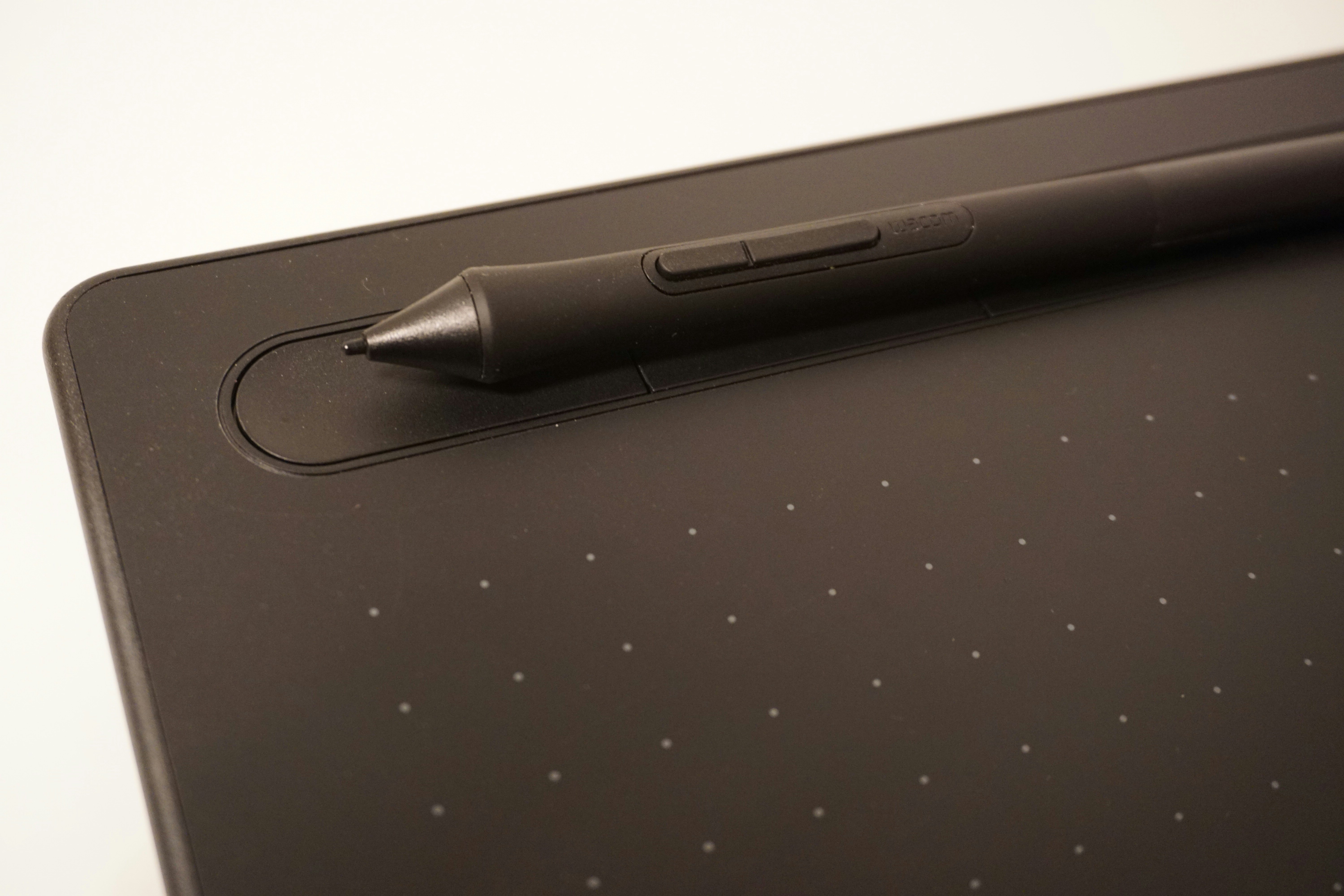 Drawing tablet with a pen on top.